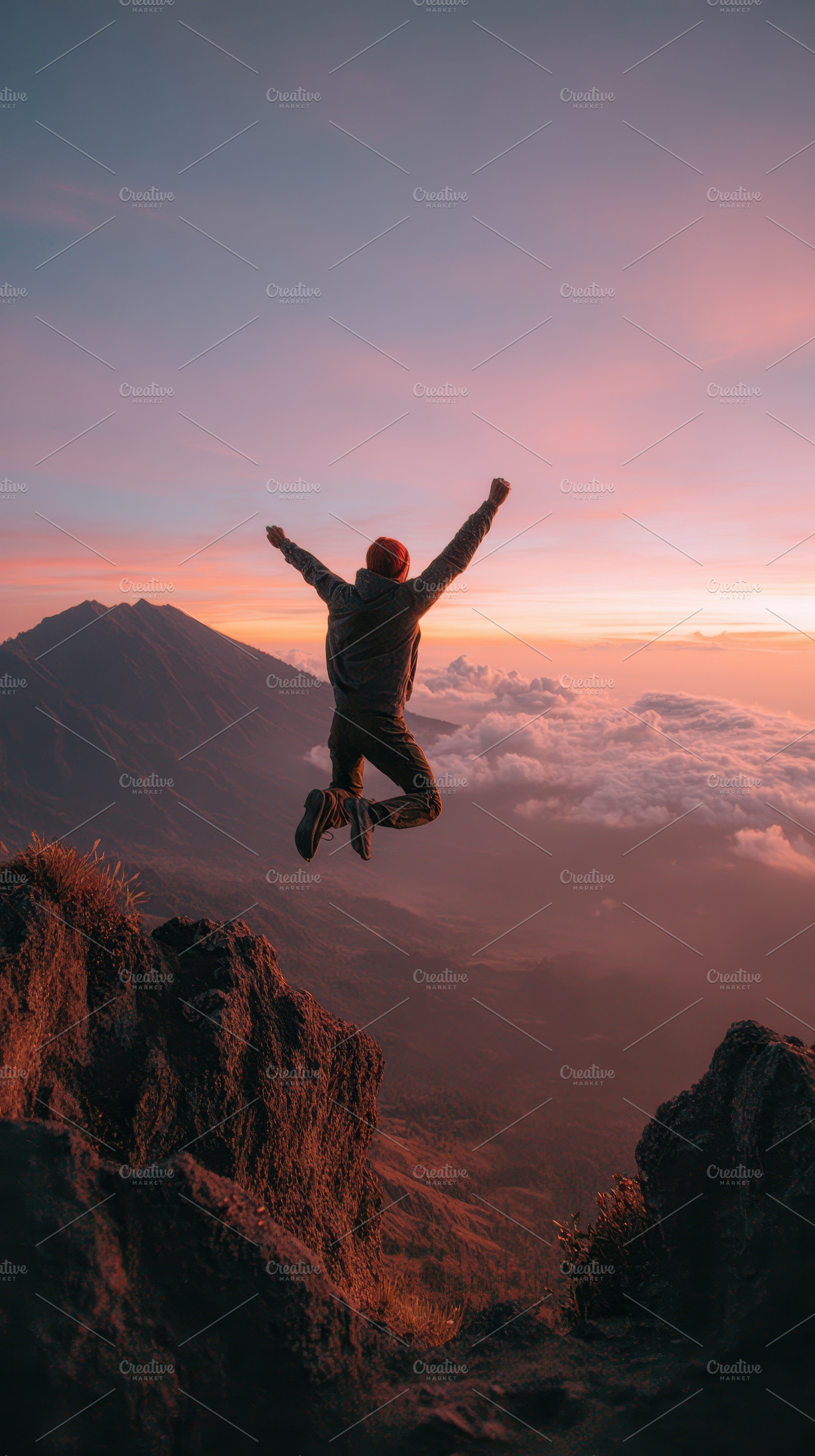 Man jumping off cliff at sunset cele, a Photo by Pixeness Studio