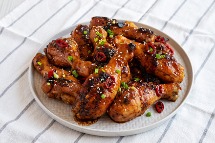 Homemade Easy Sticky Chicken Drumsticks on a Plate, side view., a Food & Drink Photo by LiudmylaChuhunova