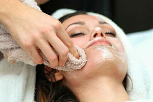 Beautician removing face mask with towel from young woman's face, an Abstract Photo by Antonio Gravante Market