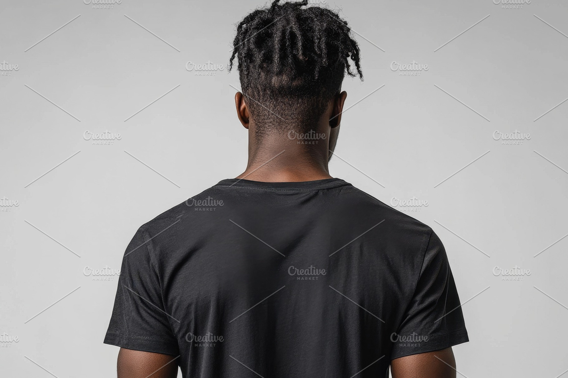 Male model showcasing black t-shirt, a Photo by Tanuart