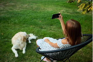 Young girl takes selfie in garden