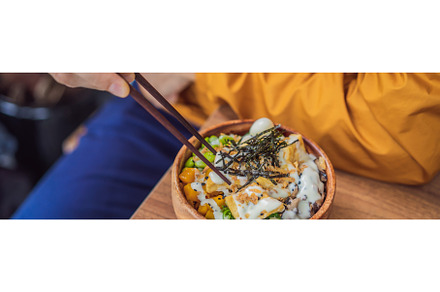 Man eating Raw Organic Poke Bowl, a Food & Drink Photo by Elizaveta Galitskaya
