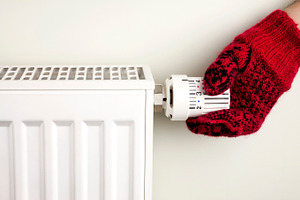 Hand holding radiator thermostat, an Industrial Photo by BOOCYS