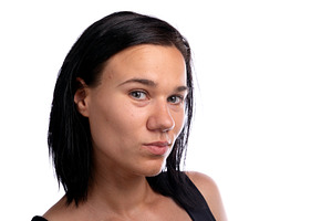 Close-up portrait of a young woman with dark hair against a whit, a Person Photo by Ales Munt