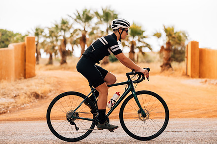 Side view of young woman cyclist, a Sports & Recreation Photo by Artem Varnitsin