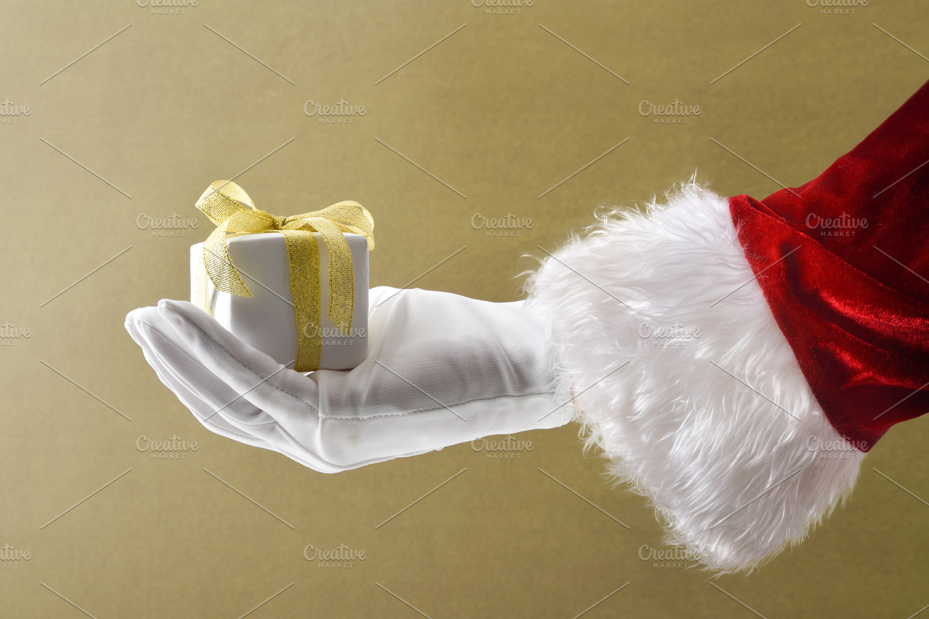 Santa Claus holding a gift package on brown isolated background, a Holiday Photo by Davizro's Market