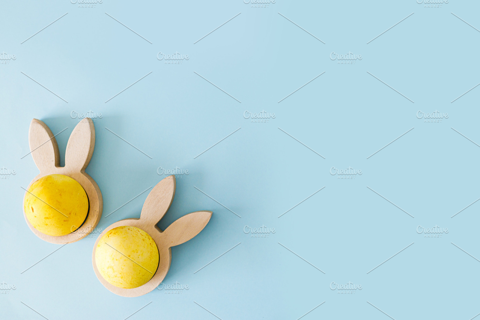 Easter flat lay. Stylish easter egg in wooden bunny ears holder, a Holiday Photo by Sonjachni