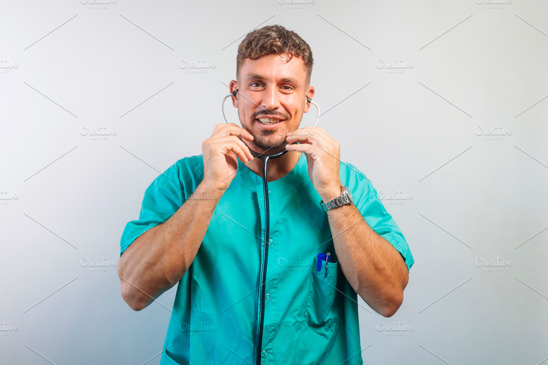 Smiling Doctor Putting On His Stethoscope, a Person Photo by karrastock