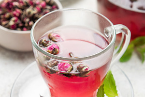 Rose tea in clear cup with mint and dried buds, a Food & Drink Photo by Olena Rudo