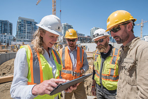 Construction Workers Reviewing Table, a Photo by Pixeness Studio