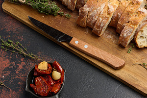 Sun dried tomatoes in a bowl and sliced ciabatta pieces on the t, a Food & Drink Photo by ndanko