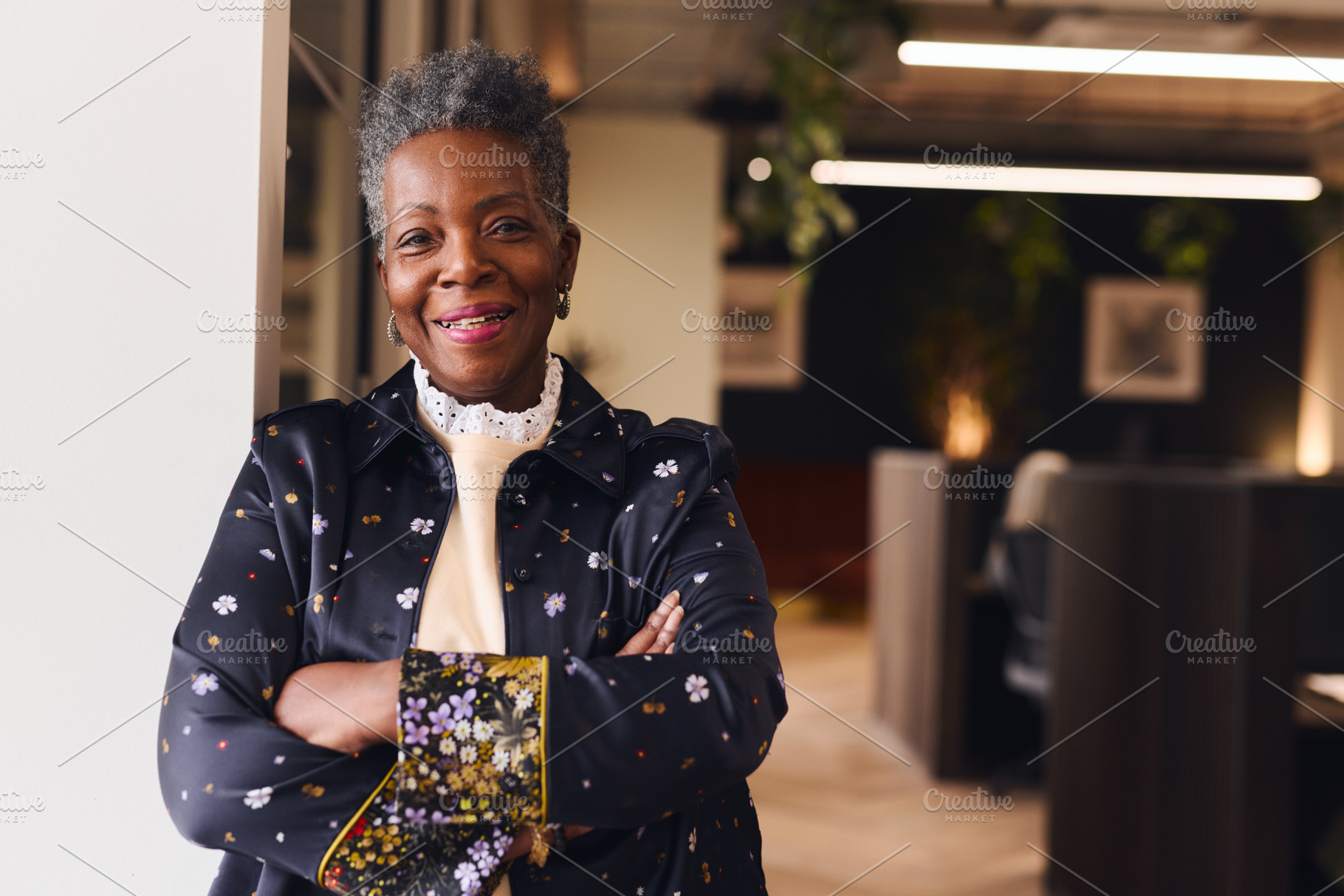 Portrait of confident senior black woman smiling and looking at camera with arm, a Technology Photo by Southworks
