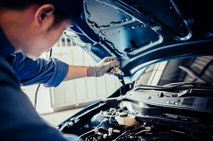 Car mechanic holding checking gear oil to maintenance vehicle by, an Industrial Photo by Ministocker