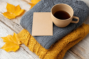 Cozy autumn mockup featuring warm clothing, a cup of coffee, and fallen leaves, a Food & Drink Photo by AlyaAnd