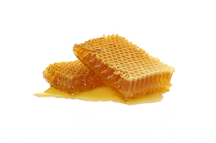Fresh honeycomb pieces isolated on white background, a Food & Drink Photo by AtlasStudio