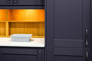 Modern kitchen interior design featuring purple shaker cabinets, white countert, a Photo by Studio ANNA