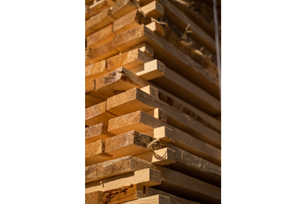 Stacked wooden planks in close-up at, an Industrial Photo by volodymyrshtun13795