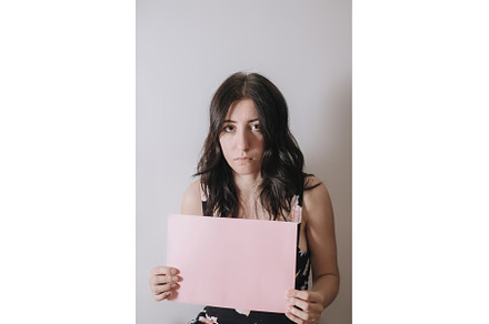 Sad young woman holding a blank, a Person Photo by zheckasmk