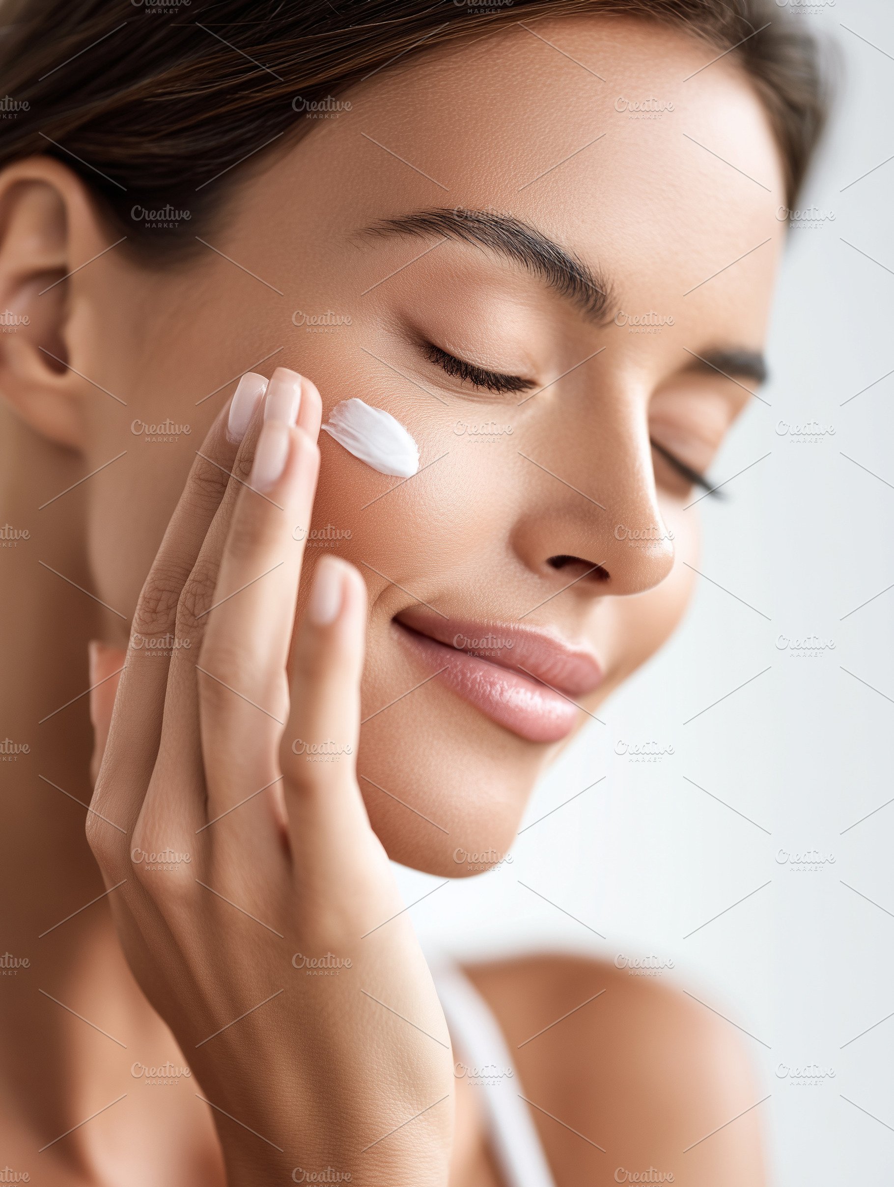 Woman gently applying face cream to, a Beauty & Fashion Photo by MistyDay