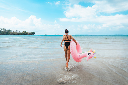 Summer travel, woman holding an inner tube, walking in the middl, a Nature Photo by Art Rachen