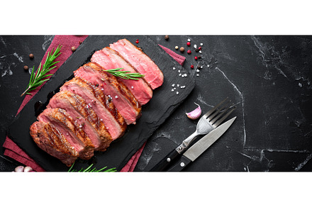 Beef steak and rosemary on a slate