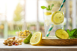 Refreshing carbonated lemon drink on a table on a terrace, a Food & Drink Photo by Davizro's Market