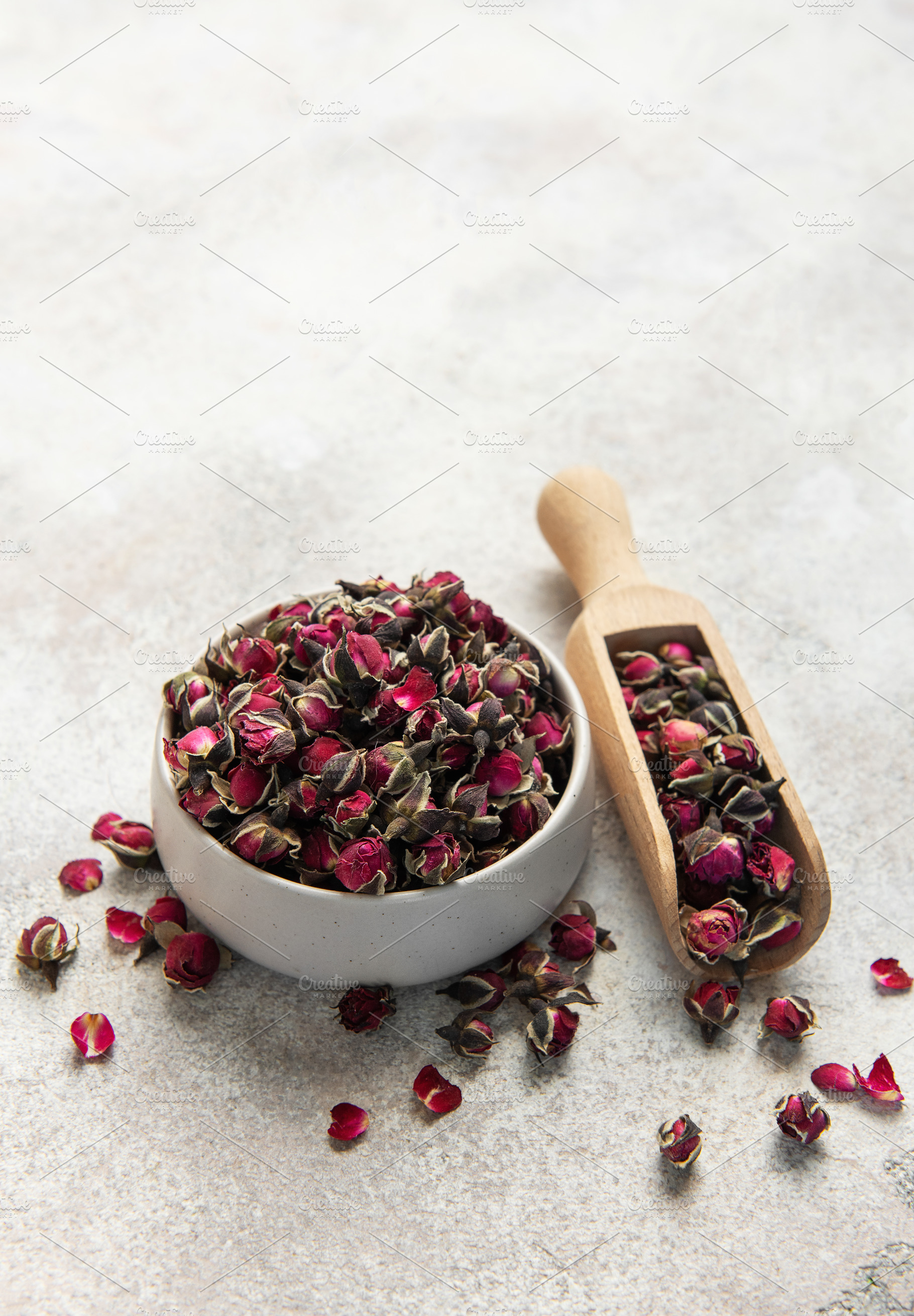 Dried rose buds with wooden scoop for herbal tea, a Food & Drink Photo by Olena Rudo