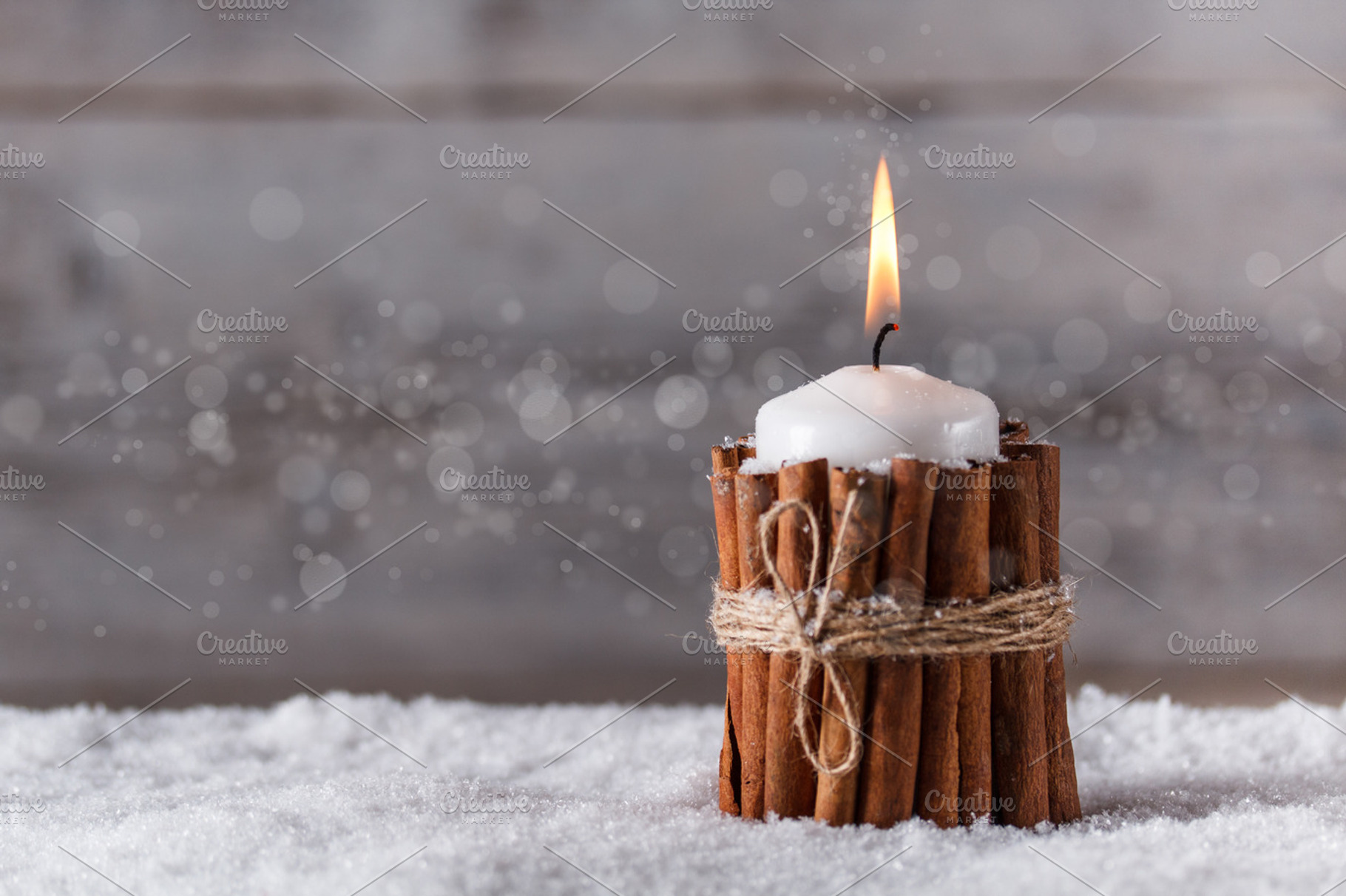 Christmas candle stock photo containing snow and cinnamon