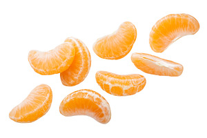 Tangerine slices flying on a white, a Food & Drink Photo by innakreativ
