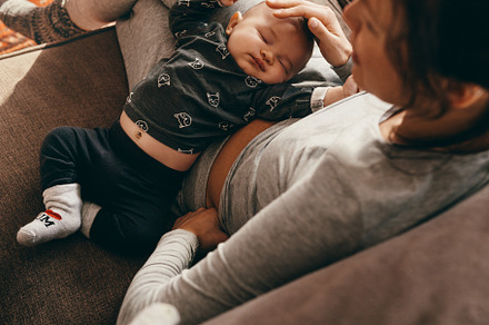 Mother sitting on couch containing adorable, baby, and beautiful, a Person Photo by Jacob Lund