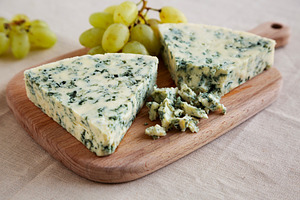 Delicious Cheese Danablu on a wooden board, side view., a Food & Drink Photo by LiudmylaChuhunova