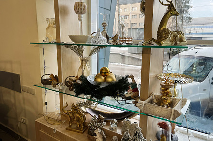 Festively Decorated Shelves With Ornaments Displayed in a Cozy Shop Window, a Photo by AS photostudio