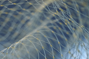 Vertical macro of yellow nylon net with selective focus on blue background. Int, an Abstract Photo by Rohan Photography