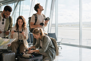 Group of young travelers in airport, a Photo by Dvoevnore photos