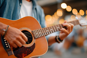 Close-up of a musician playing acoustic guitar, an Arts & Entertainment Photo by AlyaAnd