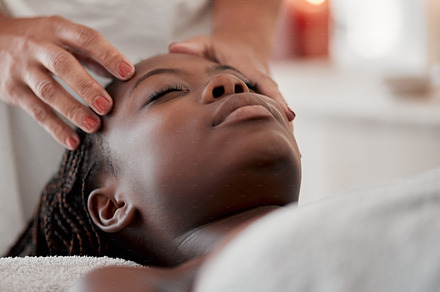 Black woman, face massage and luxury spa treatment of a young female ready for facial. Skincare, beauty and wellness clinic with client feeling calm and zen for collagen and chemical peel at salon, a Photo by Peopleimages.com