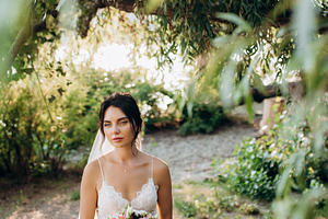 bride blonde girl with a bouquet in the forest, a Person Photo by Weddings, People, Travel