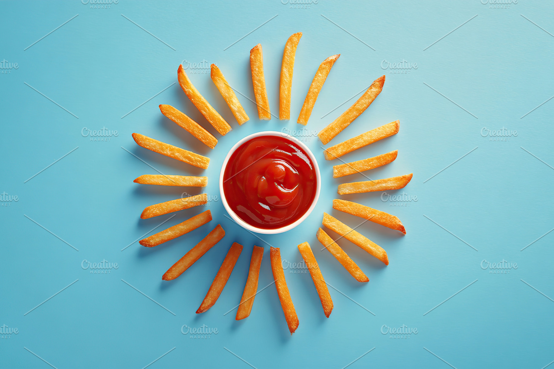 Creative arrangement of fries mimics sun rays with a ketchup center on a blue b, a Food & Drink Photo by AlyaAnd