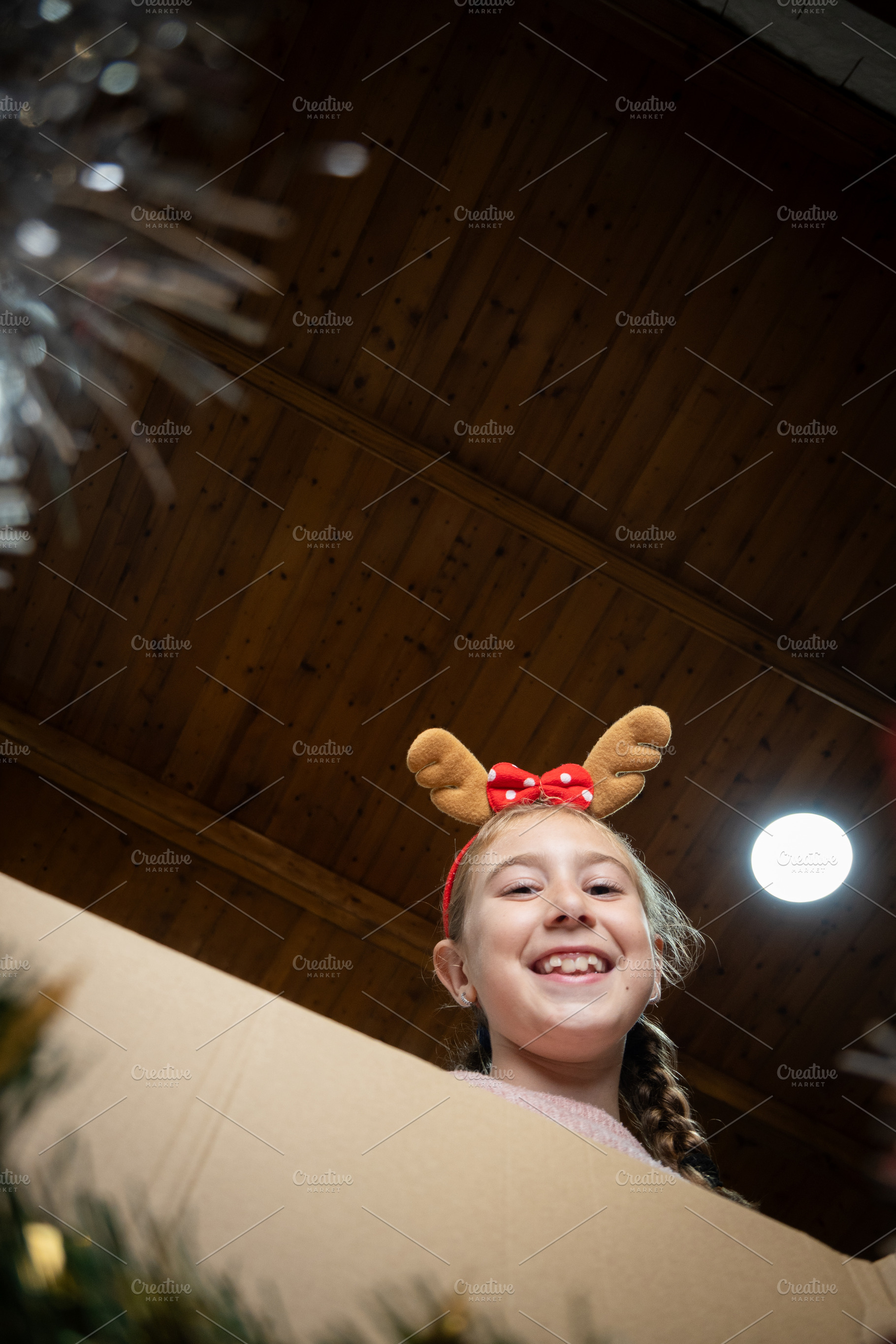 Happy girl looking inside Christmas decoration box, a Holiday Photo by etorres69