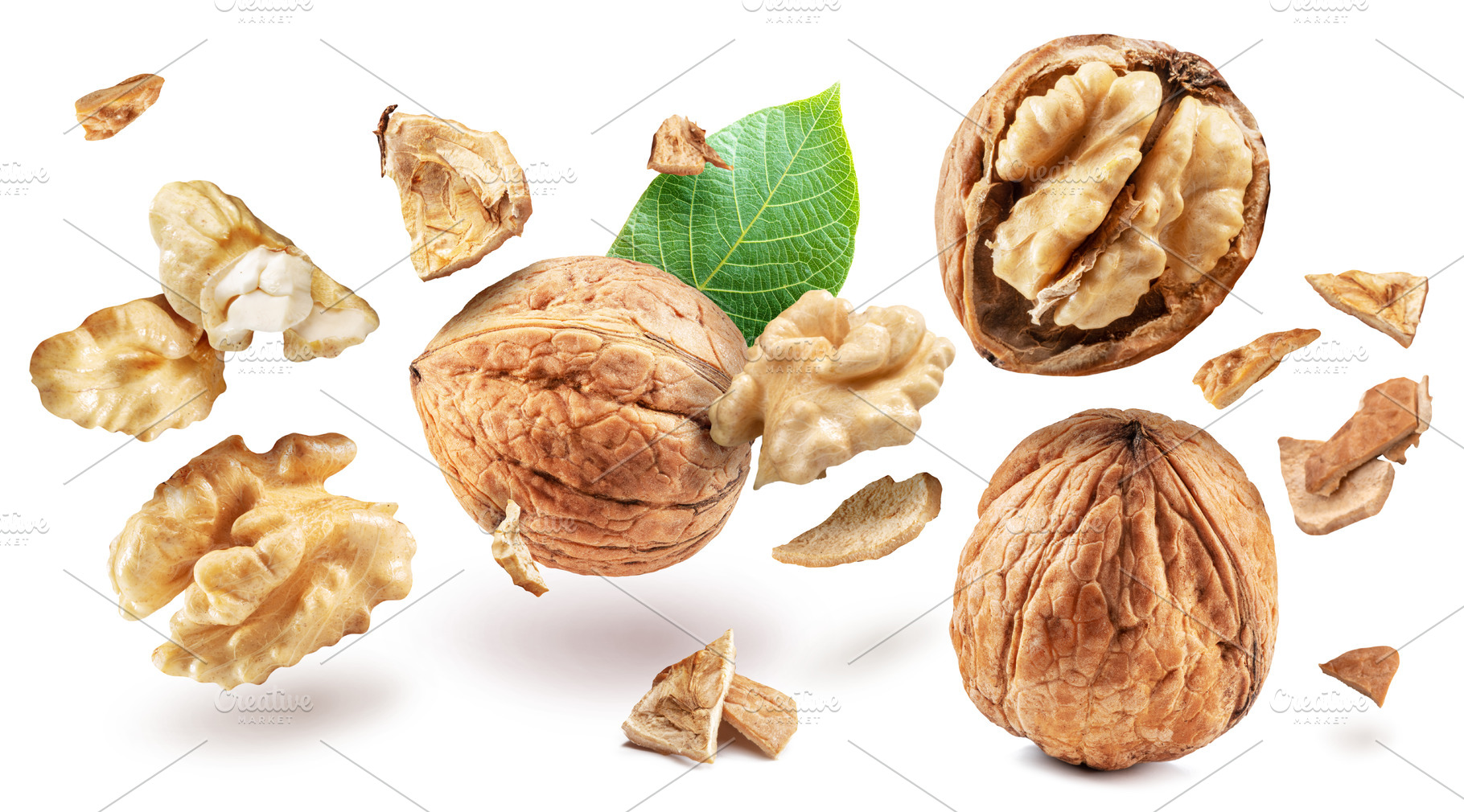 Whole walnuts and walnut kernels levitating in air on white back, a Food & Drink Photo by Volff