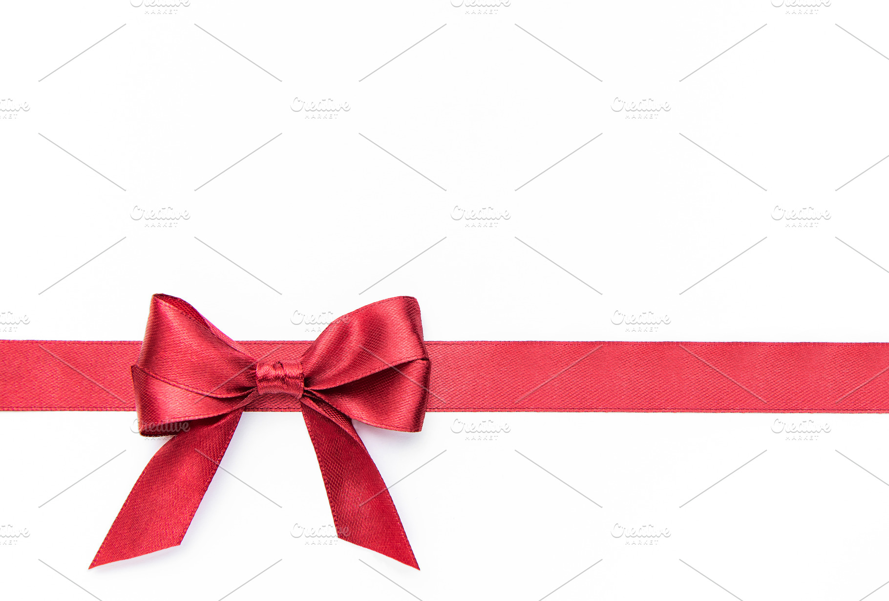 Red bow and ribbon creating a gift concept, a Holiday Photo by Olena Rudo