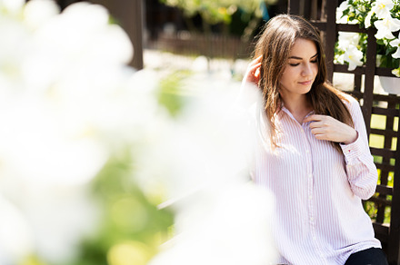 Young beautiful brunette woman in shirt sit on wooden bench with, a Person Photo by AS photostudio