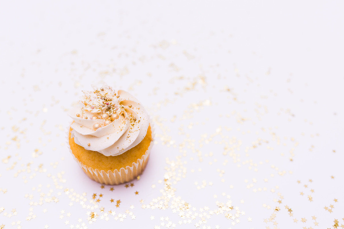 White cupcake stock photo containing food, cupcake, and sprinkes, a Food & Drink Photo by The Snap Shop (Photo 1 of 2)