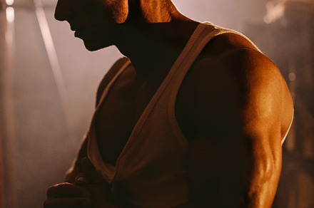 Handsome muscular man clenching a fi stock photo containing mens physique and, a Sports & Recreation Photo by Olyryk & Aglo