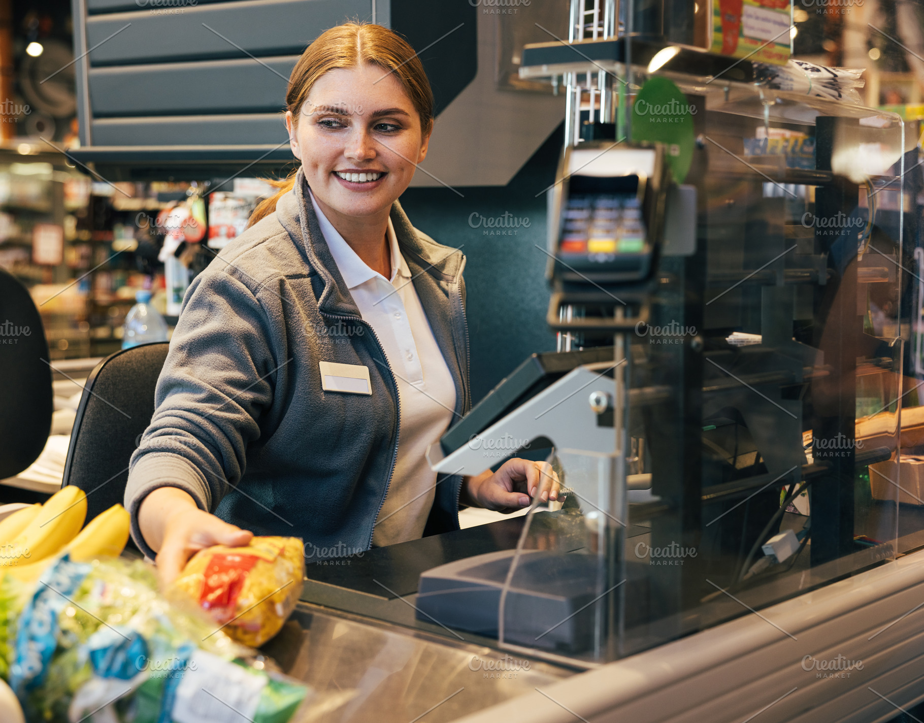 Smiling female cashier working, a Person Photo by Artem Varnitsin