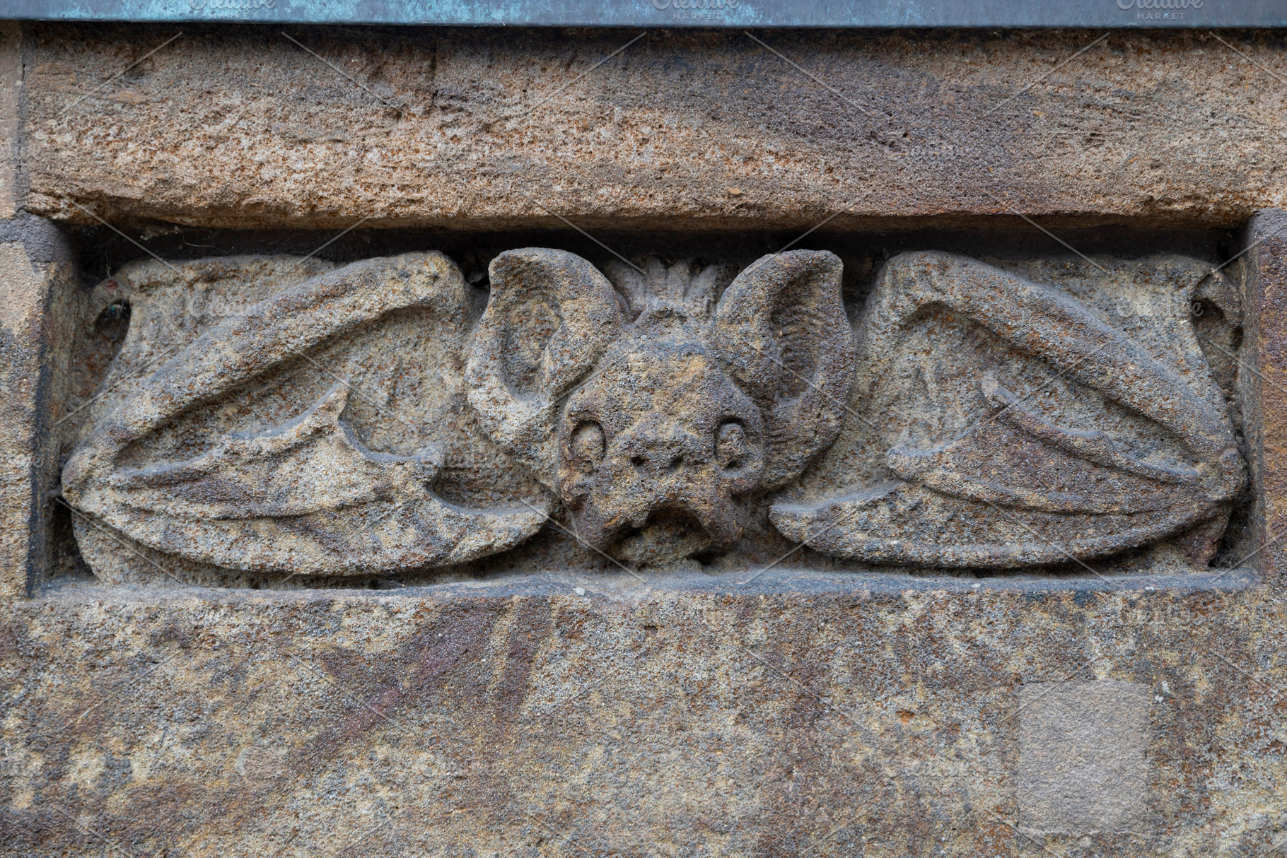 Hamburg, Germany, Detail of a stone carving depicting a bat fig, an Architecture Photo by Imaginarium