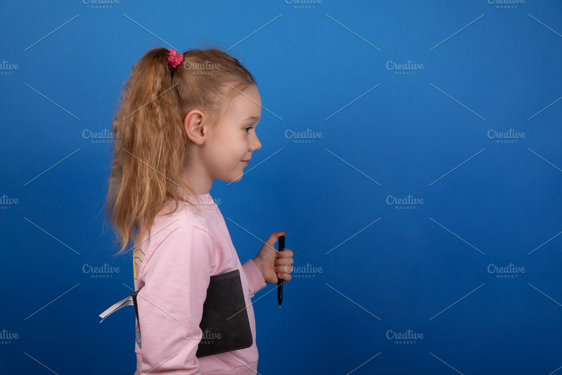 Smiling Schoolgirl with Notebook, a Person Photo by Ales Munt