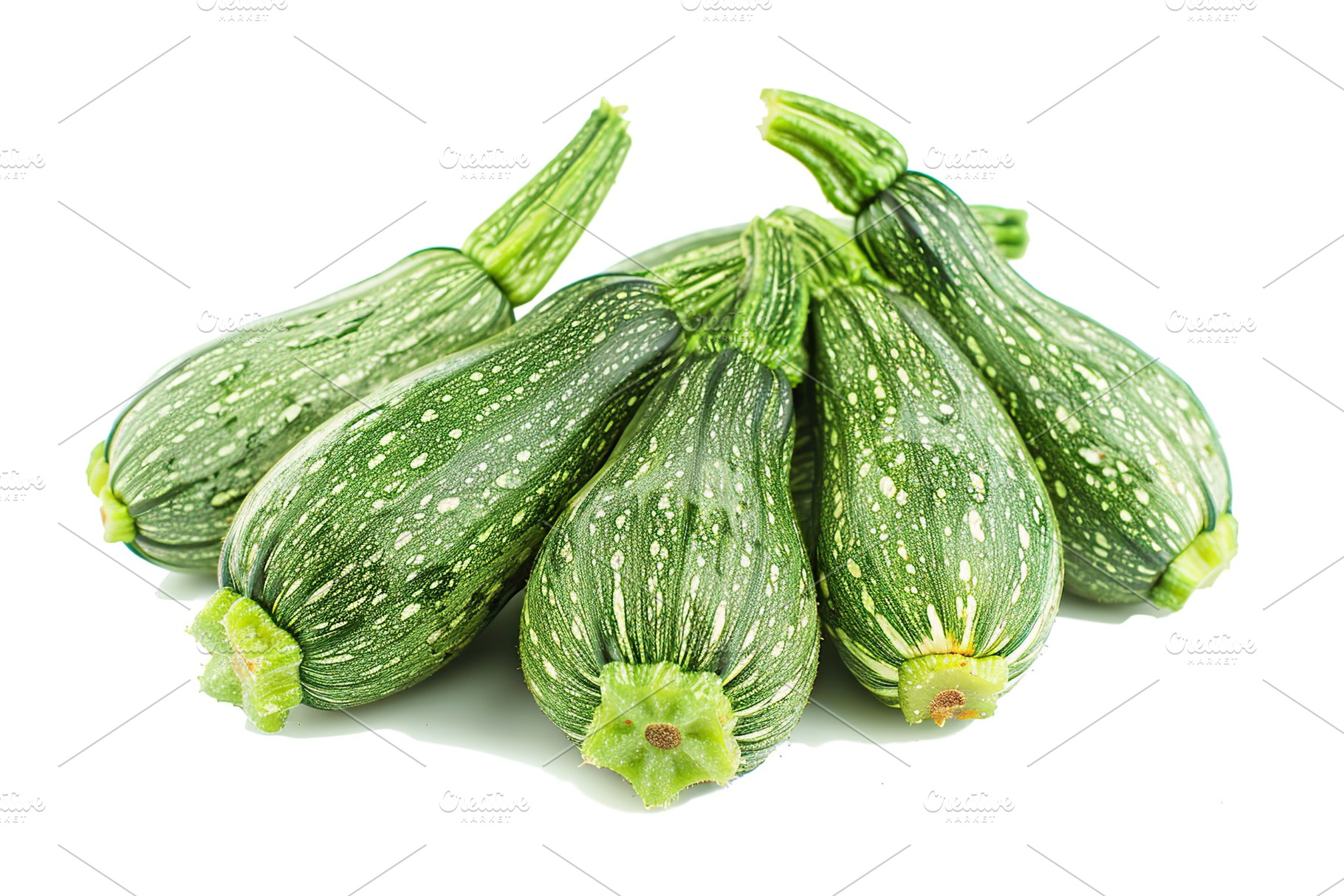 Green zucchini isolated on white background, a Food & Drink Photo by AlyaAnd