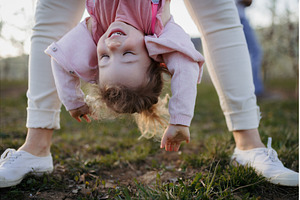 Parent lifting children upside down, a Nature Photo by HalfPoint