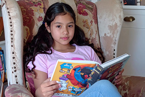 A girl reading comics at sofa, a Person Photo by DanFLCreativo